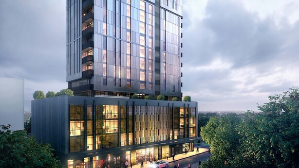 A modern high-rise building with a glass facade, multiple balconies, and a lower section with a commercial ground floor. - Burwood Apartment (Burwood)