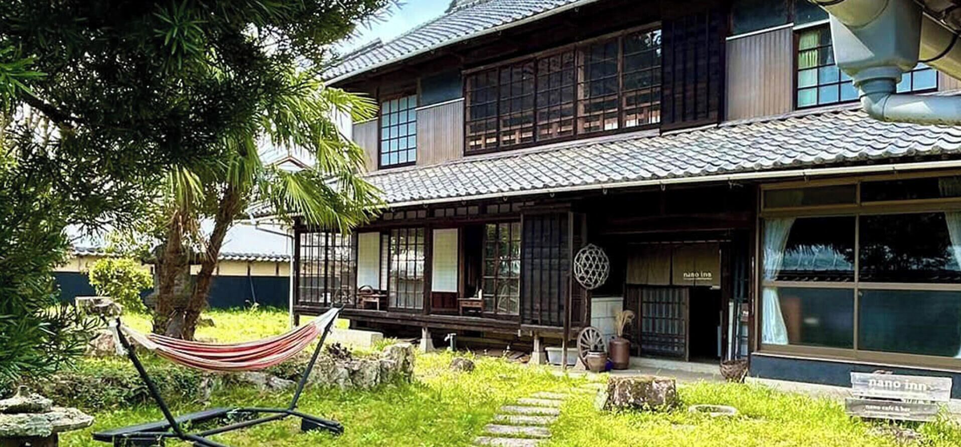 A traditional Japanese house with a wooden exterior, a tiled roof, and a front porch.