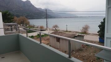 A balcony with a view of a lake and mountains.