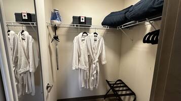 A small, compact room with a bunk bed, a drying rack, and a mirror.