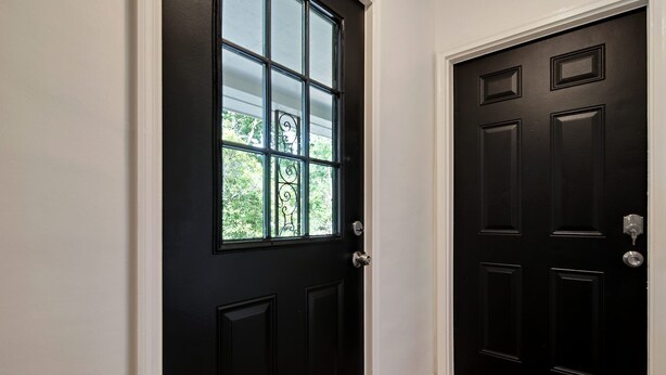 A black door with a window and a doorbell. - CorporateHousingSavannah.com (Savannah)