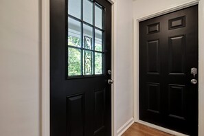 A black door with a window and a doorbell. - CorporateHousingSavannah.com (Savannah)
