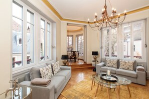 A spacious living room with two grey sofas, a glass coffee table, and a chandelier. - Colmar centre historique
Place des Dominicains
Alsatian Elegance Since 1894 (Colmar)