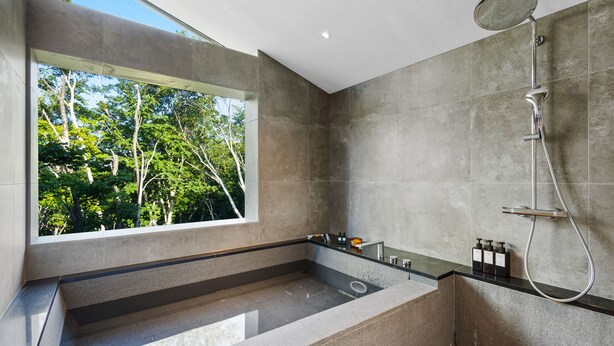 A modern bathroom with a large window, a freestanding bathtub, and a shower system. - Meikeikyo Hanazono (Kutchan)