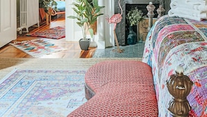 A room with a brick wall, a white fireplace, and a bicycle decoration. - The Bohemian Suite (Staunton)