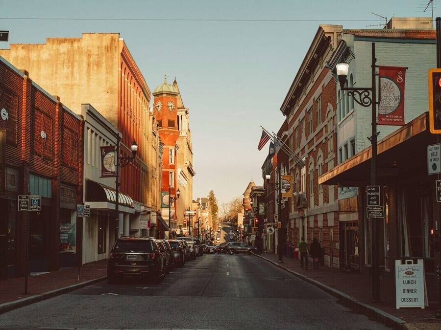 A street view with historic buildings, a clock tower, and a sign for 'Historic Downtown'.