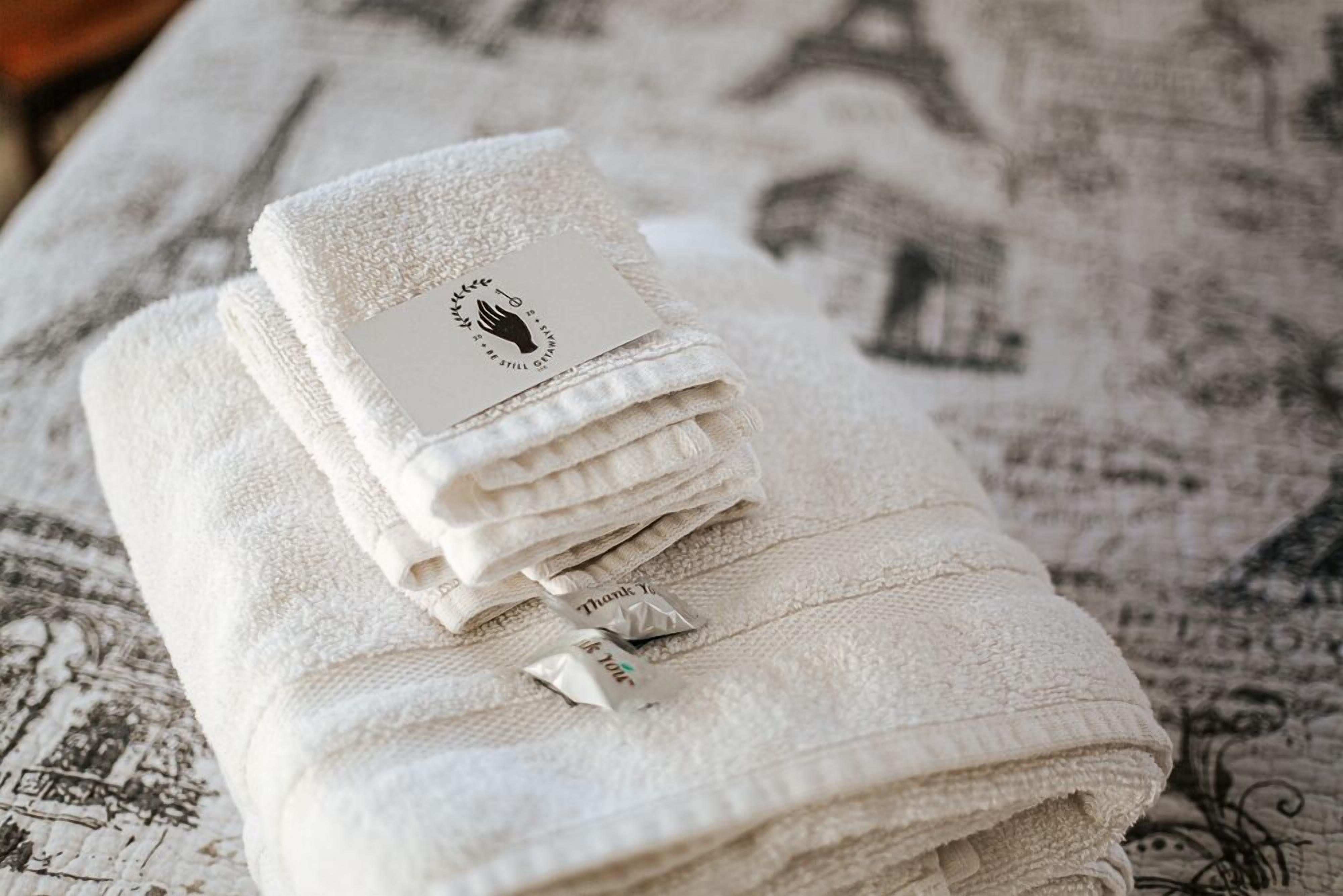 A stack of folded towels with a tag on top.