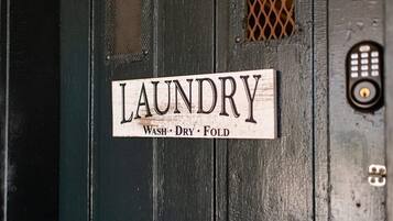 A sign on a door that reads "LAUNDRY Wash, Dry, Fold."