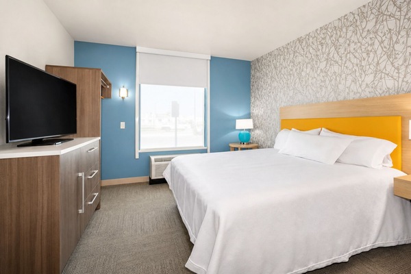 Unwind in a crisp king bed with calming daylight.