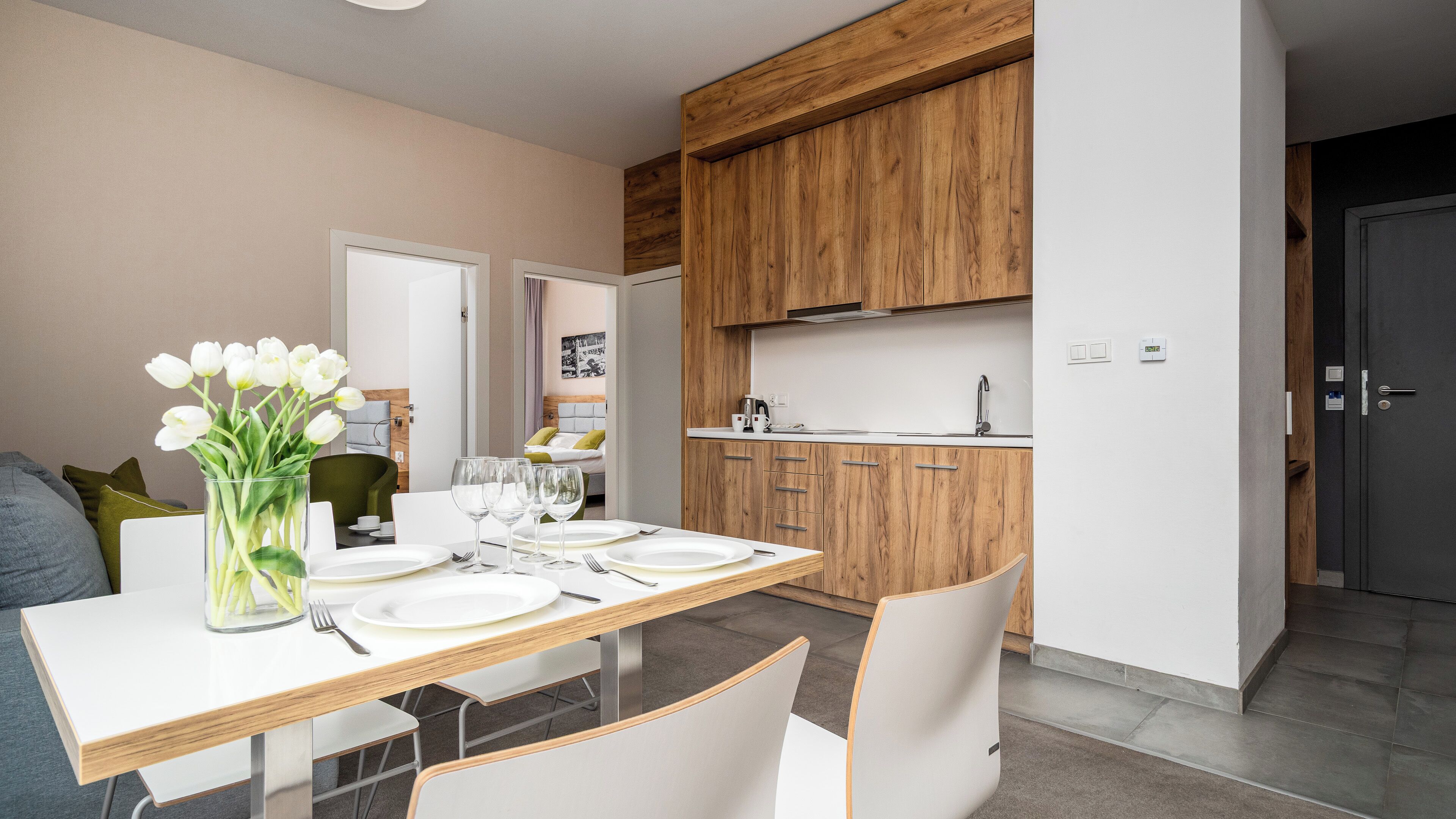 A modern kitchen with wooden cabinets and a white countertop.