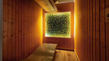 Stunning hallway with a unique wall feature and wooden floor.