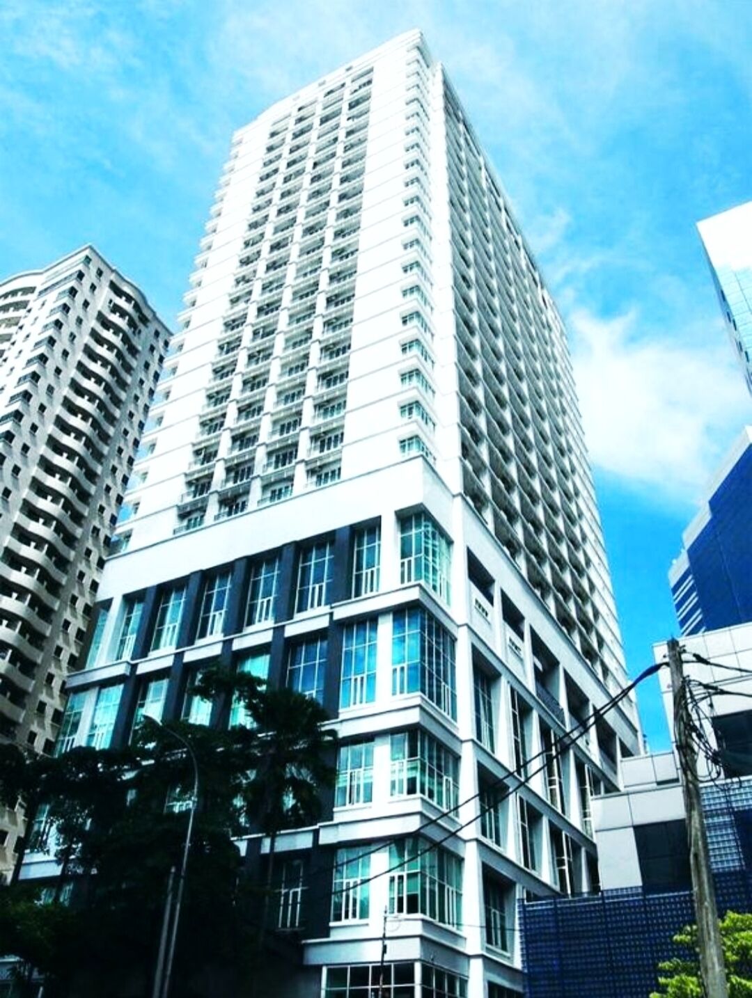 A high-rise building with multiple floors, large windows, and a modern architectural design.
