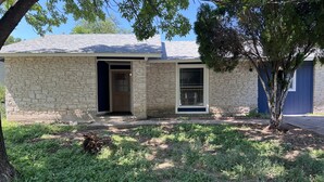 A stone building with a front door and a window. - Pristine Bungalow in East Austin (Austin)