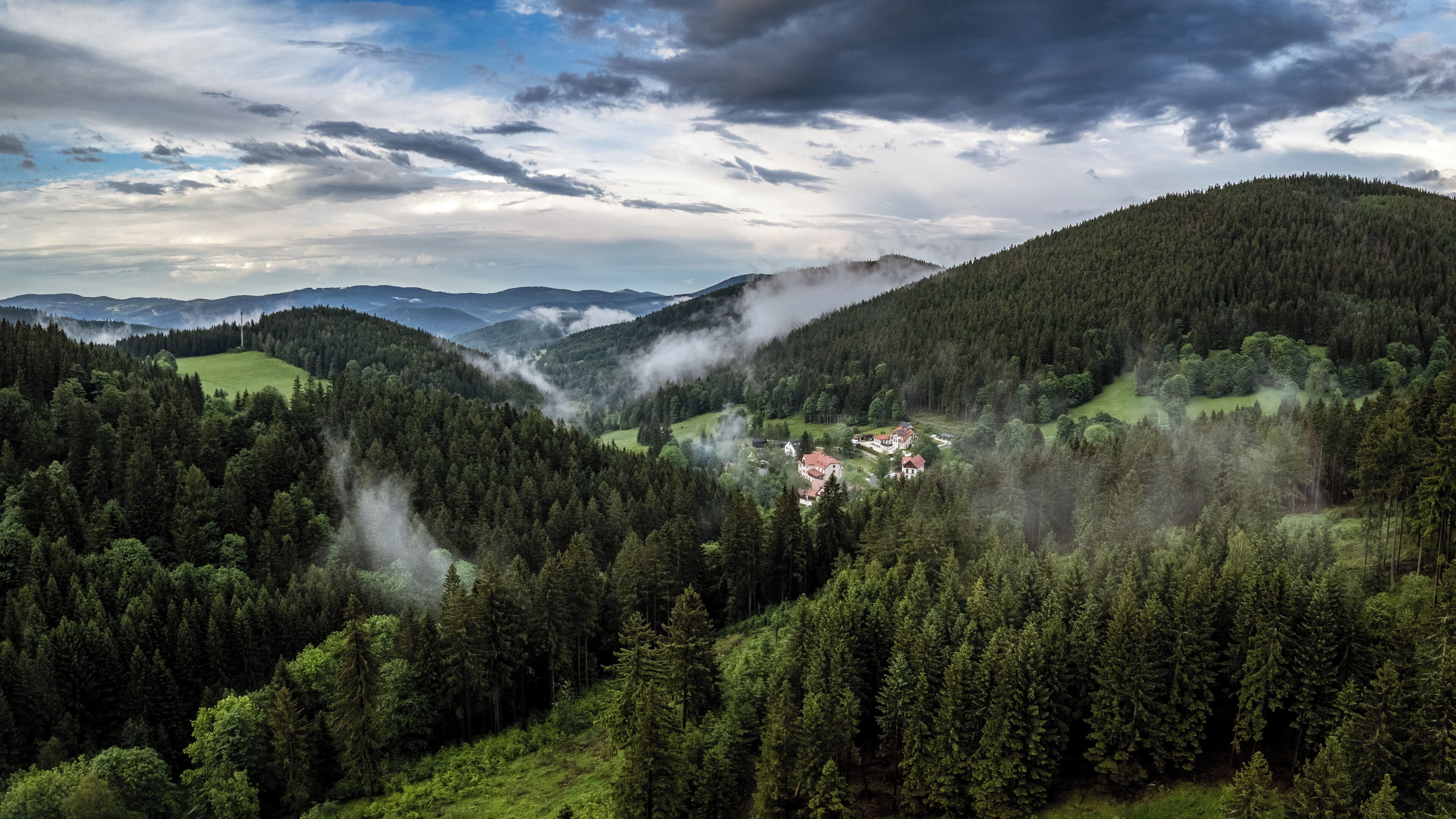 A mountainous landscape with a village nestled in a valley.