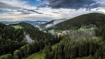 A mountainous landscape with a village nestled in a valley.