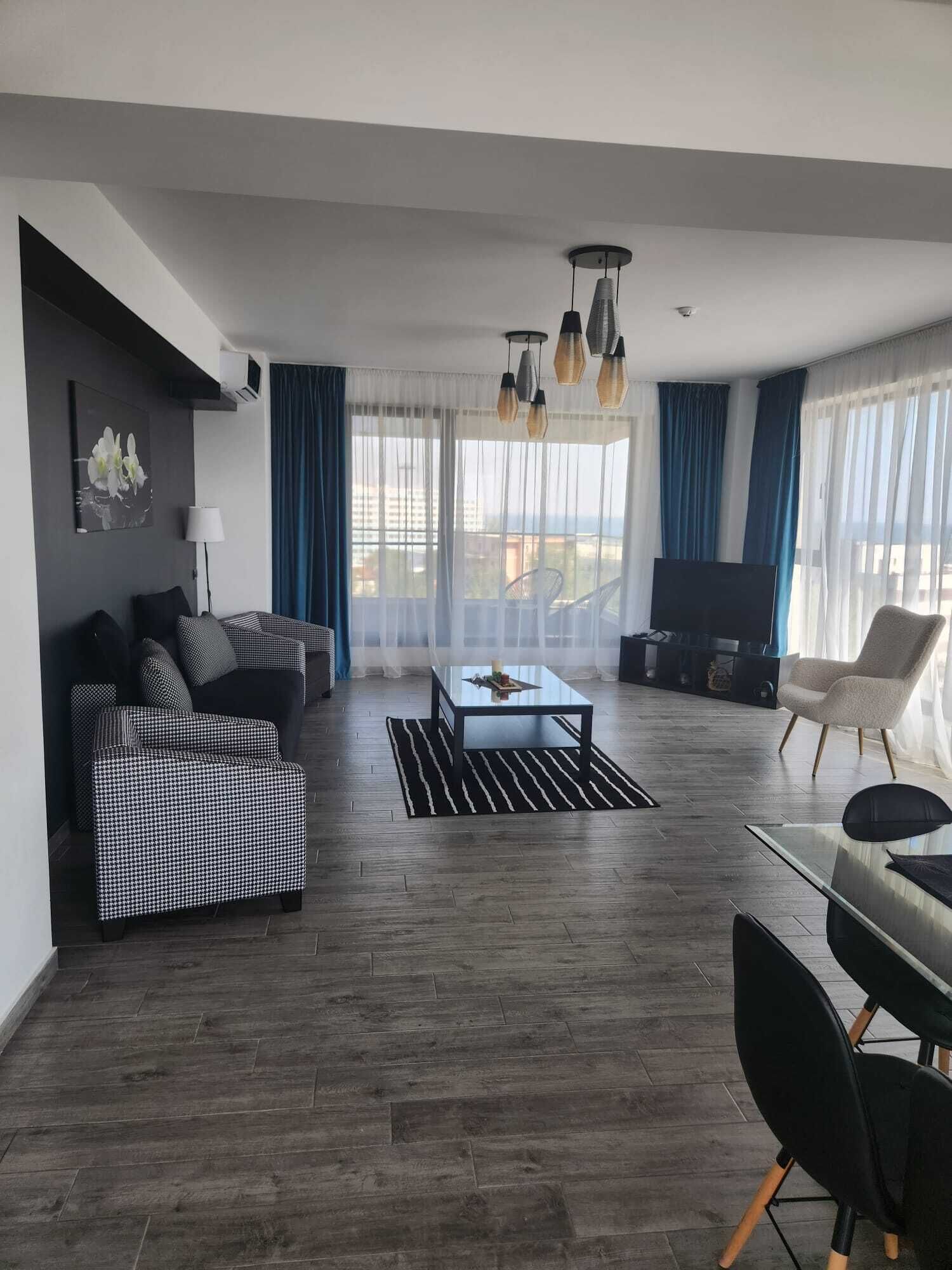 A modern living room with a sofa, a coffee table, and a TV.