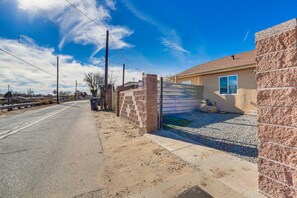 Secure gated entrance leads to a residence.