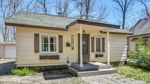 A single-story house with a front porch, a mailbox, and a small window.