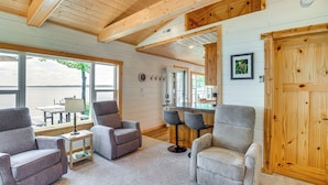 A cozy interior with wooden beams, a bar area, and seating.