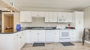 A modern kitchen with white cabinets, a microwave, a dishwasher, and a stove. - Sun-soaked Okeechobee Retreat w/ Canal Views! (Okeechobee)