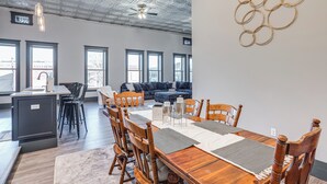 A modern dining area with a wooden table, chairs, and a ceiling fan. - Florence Vacation Rental w/ Rooftop Deck! (Florence)