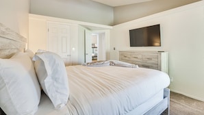 A bedroom with a bed, a ceiling fan, a TV mounted on the wall, and a dresser. - Peoria Home w/ Private Pool, Hot Tub, & Gas Grill! (Peoria)
