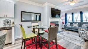 A modern living room with a dining area, a gray sofa, and a red rug. - Atlanta Home w/ Patio, 8 Mi to Downtown + Aquarium (Atlanta)