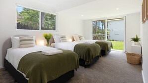 A hotel room with two beds, a small balcony, and a view of the outdoors. - Coastal Escape – waterfront reserve on Jervis Bay (Vincentia)