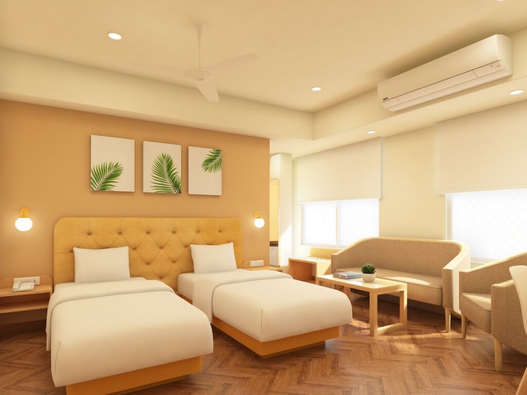 A hotel room with a large bed, two bedside tables, a sofa, a small table with a plant, and a ceiling fan.