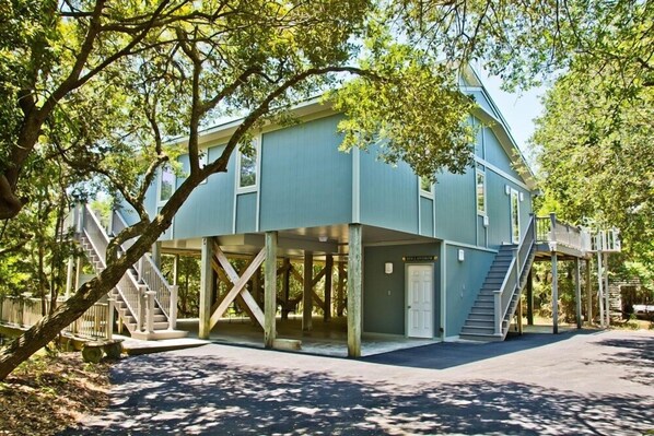 A two-story building with a covered porch and a staircase leading to the upper floor. - Hollandaise, Oceanview House in Emerald Isle, NC! (Emerald Isle)