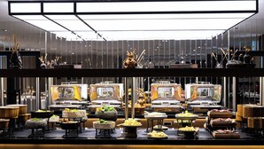 A buffet setup with multiple food stations, including a variety of dishes and a central decorative element. - Aliba Hotel  (Edirne)