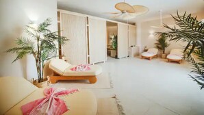 A spacious living area with a ceiling fan, a sofa, and a lounge chair. There are potted plants and a sliding door leading to another room. - Amadeus Apartments in Caesar Resort&Spa,Long Beach.
 (Nicosia)