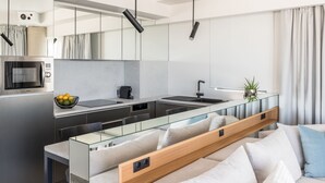 A modern kitchen with a glass island, stainless steel appliances, and a minimalist design.