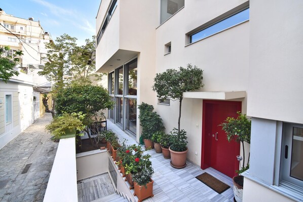 Stroll through this serene, courtyard surrounded by modern buildings with large windows.