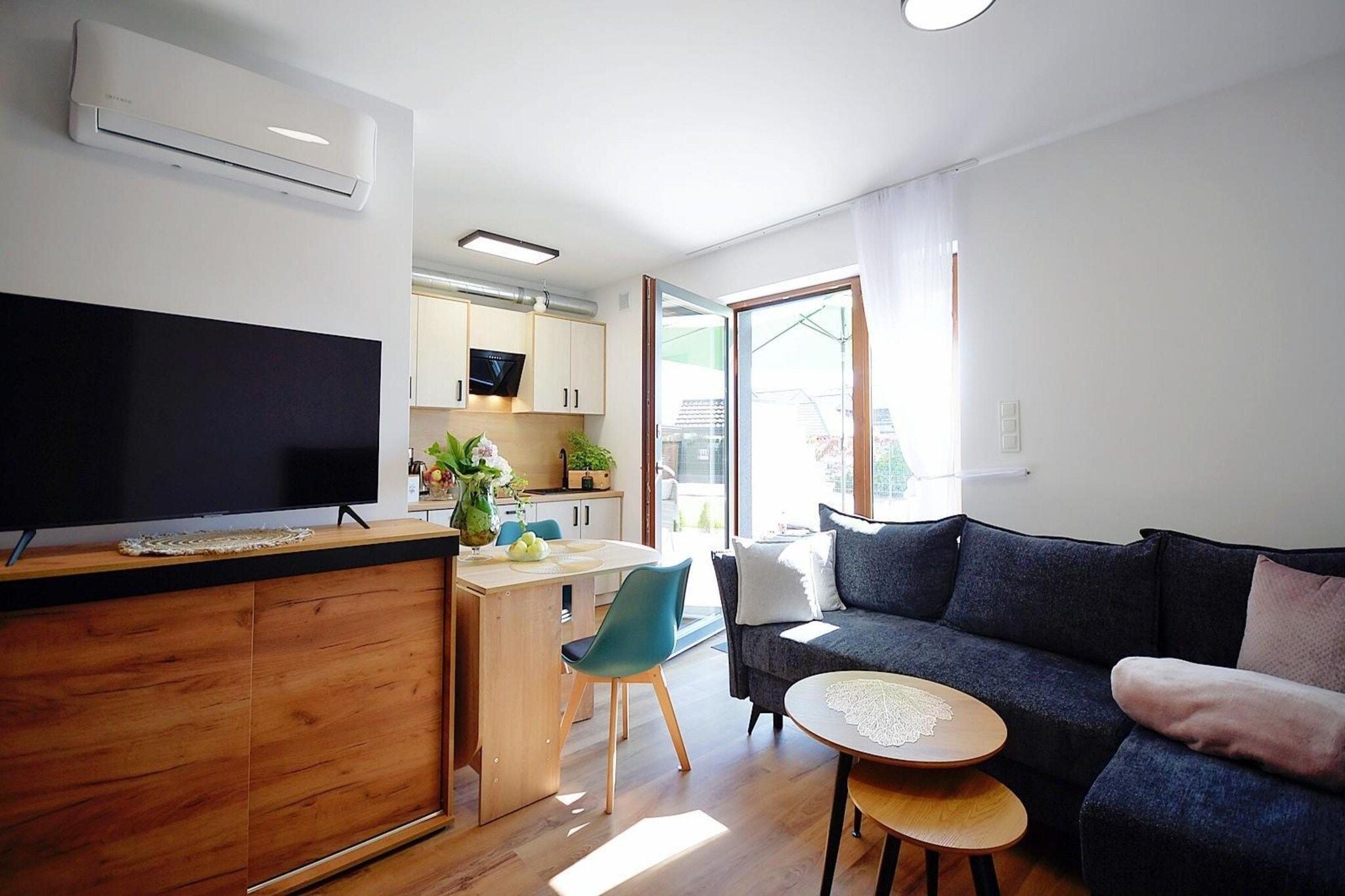 A modern living space with a kitchen, dining area, and seating area.