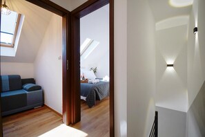 A room with a bed, a sofa, and a skylight. - Holiday homes with terraces, Mielenko (Mielenko)