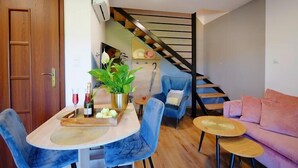 A modern living room with a dining area, a staircase, and a sofa. - Spacious holiday homes with terraces, Mielenko (Mielenko)