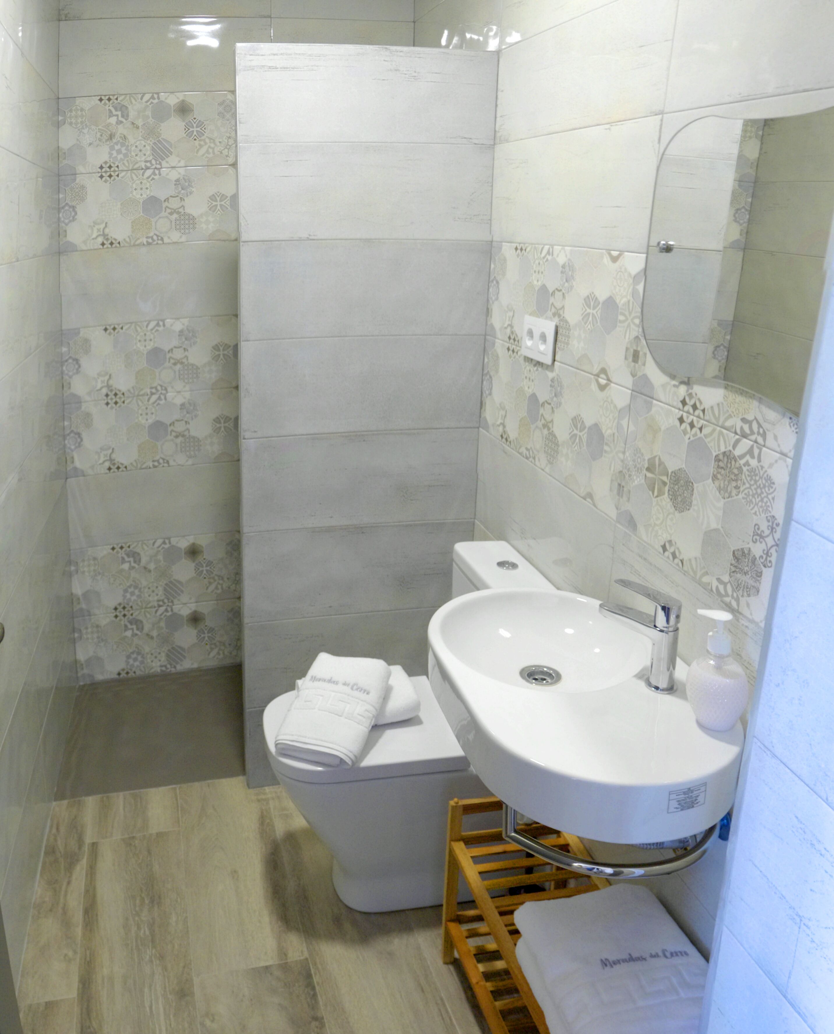 A bathroom with a toilet, sink, and shower.