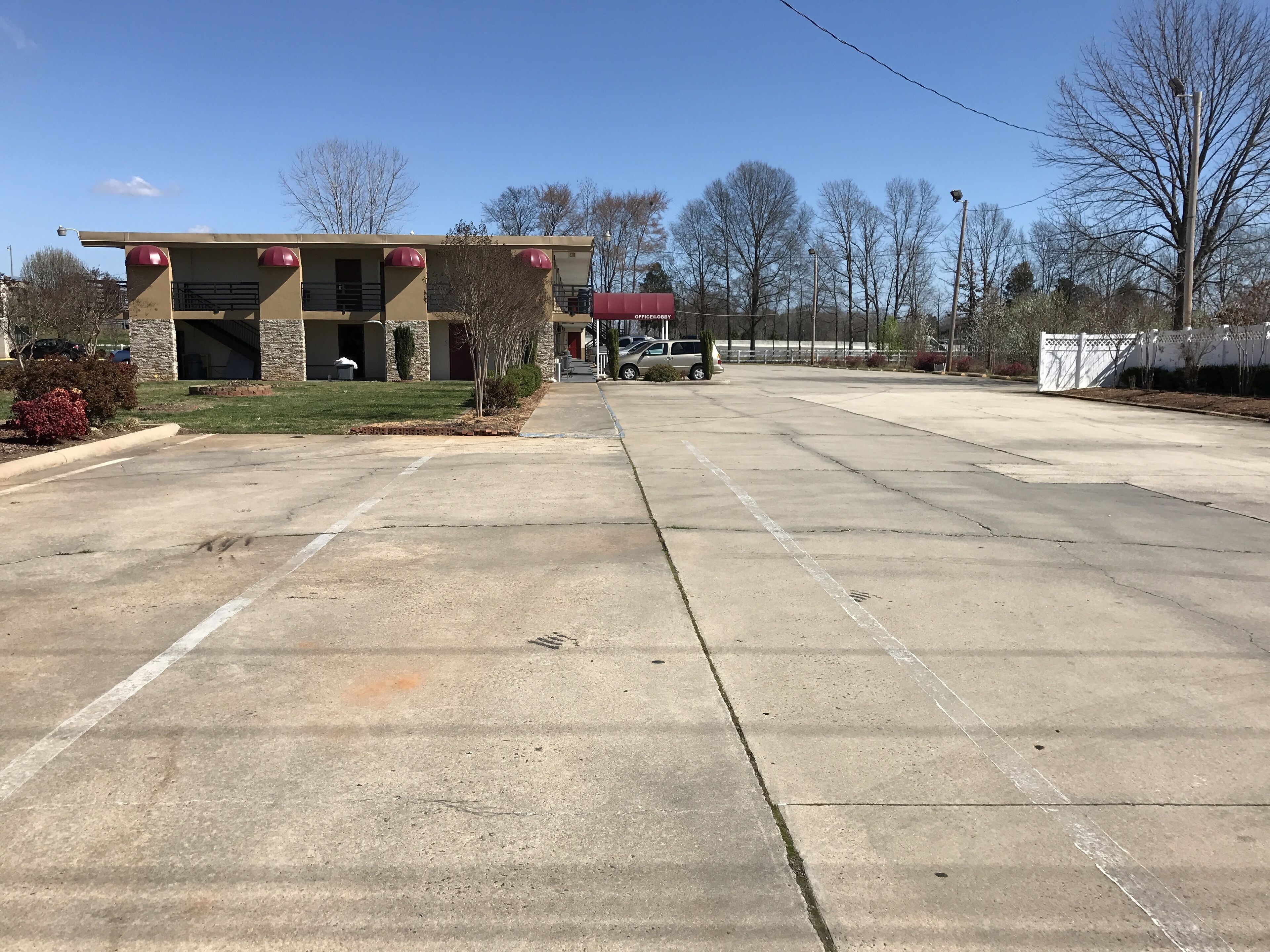A parking lot with a building in the background.