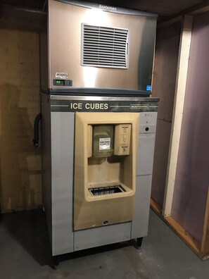 A Scotman ice cube dispenser with a push button to eject ice. - Royal Regency Inn (Rock Hill)