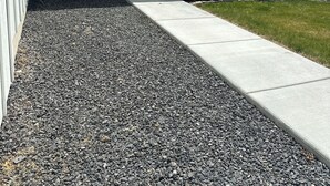 A residential house with a gravel driveway, a door, and two green chairs outside. - Brand Spankin' New 4 bedroom home Sleeps 8 Pet friendly (Kimberly)