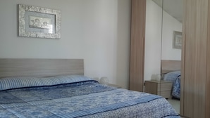 A bedroom with a bed, a dresser, a mirror, and a framed picture on the wall. - Palazzo Di Donna Penthouse terrace view Vesuvius strategic to Pompeii, Amalfi coast (Sant'Egidio del Monte Albino)