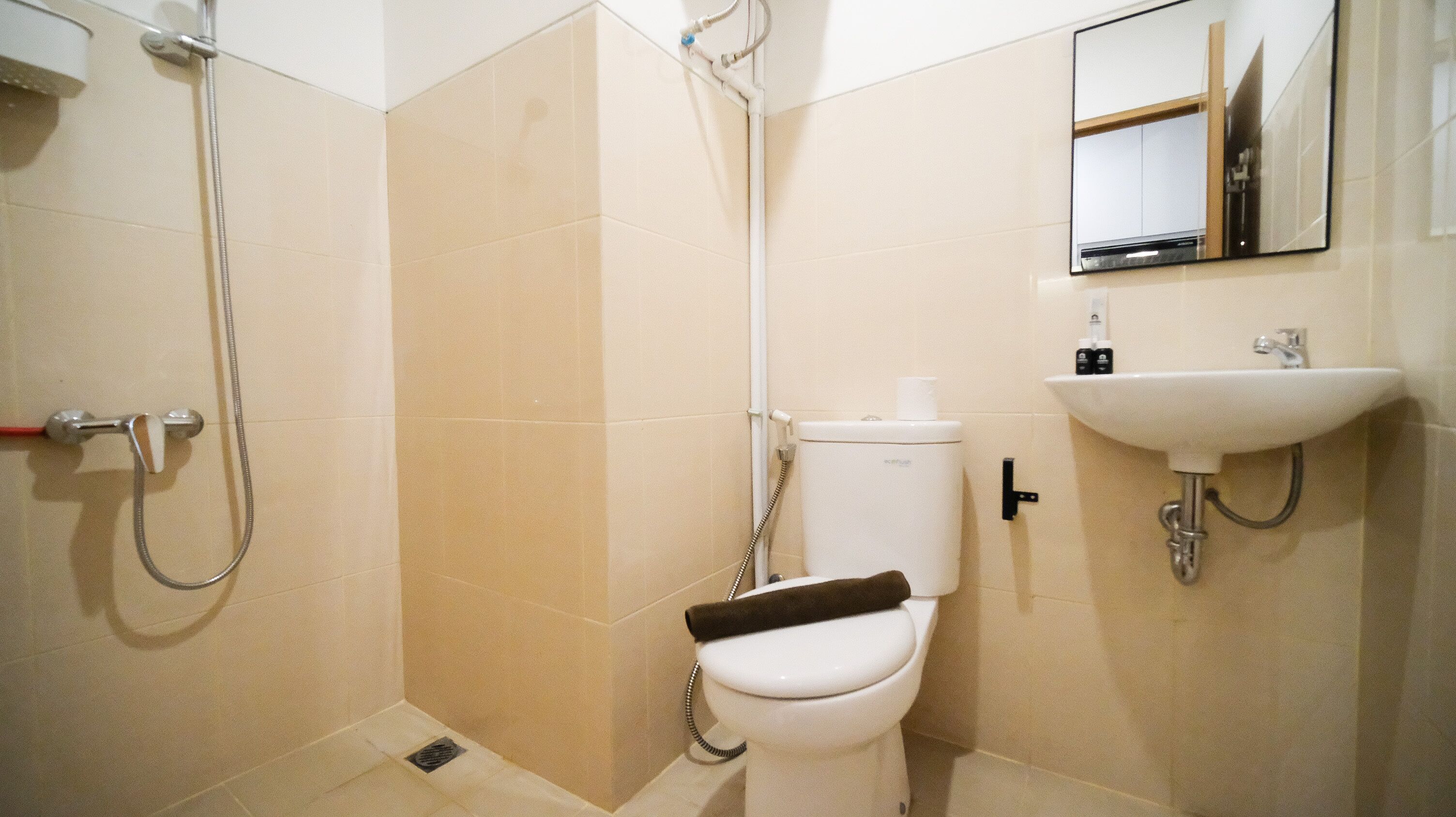 A bathroom with a shower, toilet, and sink.