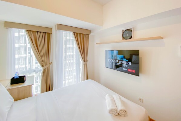 Relax in comfort with a large bed, flat-screen TV, and convenient amenities.
