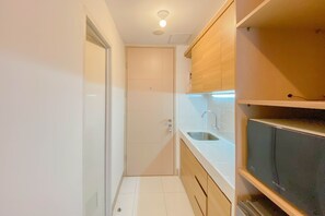 Studio | Private kitchen | Full-sized fridge, stovetop - Tidy And Homey Studio At Tokyo Riverside Pik 2 Apartment (Teluknaga)