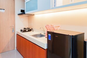 Studio | Private kitchen | Full-size fridge, stovetop - Nice And Simply Look Studio Apartment At B Residence (Pagedangan)