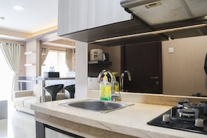 Apartment | Private kitchen | Full-sized fridge, stovetop, rice cooker, cookware/dishes/utensils - Best Deal Stylish 2Br At Apartment Gateway Pasteur (Cimahi)