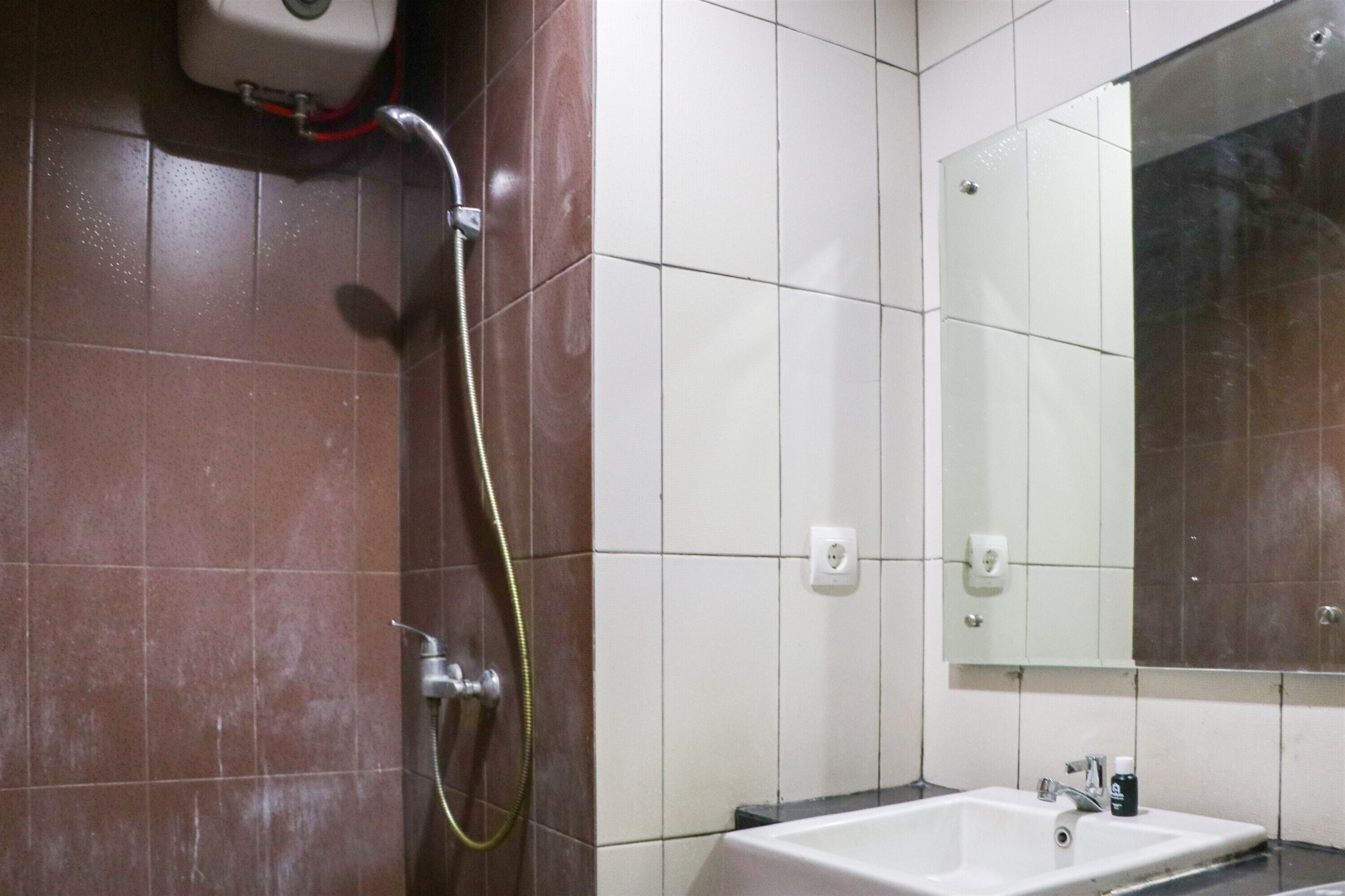 A bathroom with a shower, a sink, and a mirror.