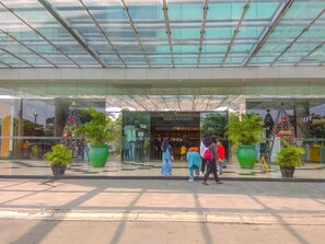A modern building with a glass facade and a sign for 'MATAHARI'. - Good Deal And Homey Studio At Park View Condominium (Depok)