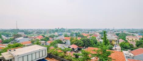 A rooftop pool with a view of a residential area.